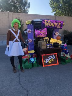 a woman standing next to a table with decorations on it