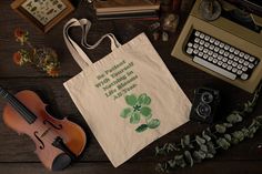 Embrace the virtue of patience and a touch of good fortune with the "Patience Tote Bag." Adorned with a vibrant four-leaf clover and the inspiring caption "Be Patient," this tote bag is a perfect accessory for those who appreciate meaningful designs and the symbolism of luck and patience in their daily lives. ⭐ Key Features and Sizing Size of Tote: 15" x 16" and Handles are 20"  Symbolic Four-Leaf Clover Design: Featuring a beautifully rendered four-leaf clover, a universal symbol of luck, paired with the motivational phrase "Be Patient," this tote bag encourages positivity and a calm approach to life's challenges. Spacious and Versatile: Whether you're managing daily errands, heading to work, or packing for a casual day out, this tote bag offers ample space for all your essentials. Its ve Green Tote Bag For Personal Use, Green Canvas Shoulder Bag Gift, Cute Book Bags, Grocery Bag Aesthetic, Best Tote Bags, Clover Design, Green Tote Bag, Flower Tote, Book Bags