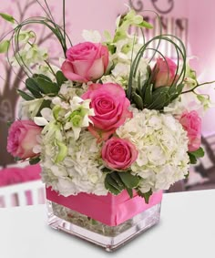 pink roses and white flowers in a square vase