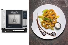 a white plate topped with onion rings next to a microwave oven filled with fried food