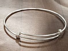 New for 2015. Now Available in Solid 925 Sterling Silver with Anti Tarnish Coating. The bracelet adjusts from 8 Inch to 9.50 Inch. The wire is 16 Gauge or 1.65mm. Make Personalized Bracelets and tell your story. Make special occasions memorable by having a keepsake piece of jewelry. Make your own celebrity style charm bracelet. Since it is sterling silver you do not have to worry about plating wearing off.. Buy one or stack up multiples, choice is yours. Need larger Quantities, please CONVO with Adjustable Round Sterling Silver Bracelet For Gifts, Adjustable Round Sterling Silver Bracelet As Gift, Adjustable Sterling Silver Round Bracelet As A Gift, Adjustable Sterling Silver Bracelet As A Gift, Classic Adjustable Nickel-free Charm Bracelet, Adjustable Bangle With Sterling Silver Clasp, Adjustable Polished Bangle Jewelry, Classic Adjustable Bangle Charm Bracelet, Classic Adjustable Charm Bangle Bracelet