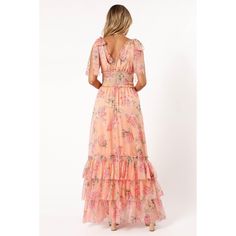 Embrace elegance with our maxi length floral dress featuring a charming v overlay neckline, tie-close shoulder straps, and exquisite shirred ruffle bodice. The drop tier A-line skirt and tiered ruffle hemline add a touch of romance. Shop now for a timeless look! Flowy Peach Maxi Dress With Ruffles, Spring Peach Maxi Dress With Ruffles, Peach Maxi Dress With Ruffles For Brunch, Peach Ruffled Maxi Dress For Spring, Peach Ruffled Maxi Dress For Brunch, Feminine Peach Maxi Dress With Ruffles, Chic Peach Maxi Dress With Floral Print, Chic Peach Floral Print Maxi Dress, Bohemian Peach Maxi Dress For Garden Party