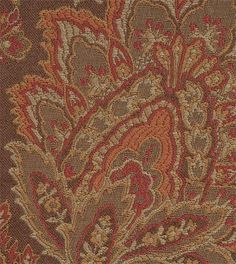 an orange and brown paisley pattern on fabric