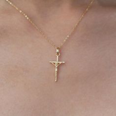 The Crucifix Pendant Necklace is a powerful symbol of faith and devotion. Crafted with exquisite detail, this pendant features a beautifully rendered crucifix suspended from a delicate chain. It serves as a reminder of the enduring significance of Christ's sacrifice and offers a timeless expression of spiritual belief. 14K gold plated Sterling silver based Cross measures 25*13mm Necklace length 18" Jewelry care needed Catholic Necklace, Crucifix Necklace, Sugar Pie, Buyable Pins, Classy Jewelry, Delicate Chain, Dainty Jewelry, Pretty Jewellery, Gold Plated Sterling Silver