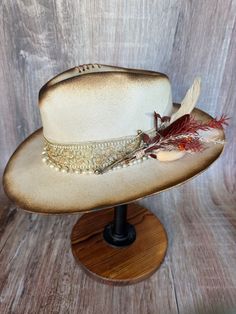 This gorgeous soft brim wool fedora shines with elegance. It's torched to perfection. It has gold accents and a pearl beaded band. It has an adjustable drawstring inner band to fit most size heads. Elegant Gold Adjustable Felt Hat, Elegant Adjustable Gold Felt Hat, Gold Fedora With Adjustable Short Brim, Gold Western Hat Band For Kentucky Derby, Western Gold Hat Bands For Kentucky Derby, Adjustable Gold Fedora With Short Brim, Adjustable Brimmed Gold Fedora, Elegant Gold Fedora Felt Hat, Elegant Gold Felt Fedora Hat