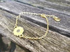 "This bracelet is perfect for anyone! You can choose a yellow sunflower or a white daisy. The metal is a gold color. The flower measures 1/2\" wide. The bracelet has an extender on it so it is adjustable, and it has a heart charm at the end. Perfect for a Mom gift, for a Christmas gift, anniversary, or a birthday. All jewelry items come in a gift box." Gold Bracelet With Birth Flower For Gift, Personalized Gold Flower Bracelets, Gold Bracelet With Birth Flower Design, Petoskey Stone, Daisy Bracelet, Memory Locket, White Daisy, Yellow Sunflower, Metal Charm