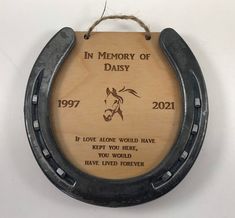 a wooden plaque with an image of a horse on it's back and the words in memory of daisy