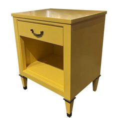 a yellow nightstand with one drawer open