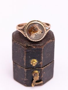 This is an absolutely adorable antique ring, dating to around 1900 It's made from solid 9ct rose gold, and is set with a reverse-carved cabochon of flawless rock crystal. The crystal has been carved with a portrait of a dog, probably a beagle or spaniel. The dog's expression is wonderful - eager and a little bit cheeky  The carving is finely detailed and has been hand coloured. The cabochon is backed with iridescent mother-of-pearl. This construction means the ring is not suitable for full time Antique Engraved Cabochon Ring For Gift, Antique Engraved Cabochon Ring Gift, Vintage Oval Cabochon Crystal Ring, Elegant Cabochon Crystal Ring, Antique Filigree Cabochon Ring Gift, Dog Expressions, Etsy Gold Ring, Rock Crystal, Antique Rings