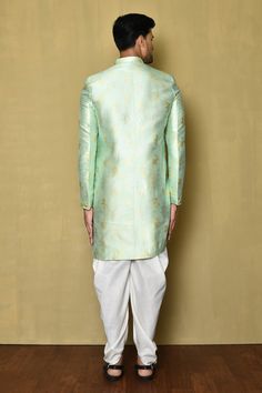 Sea green fancy jacquard asymmetric sherwani with woven abstract and floral motifs. Comes with cream katan silk patiala.
Component: 2
Pattern: Woven
Type Of Work: Floral
Neckline: Mandarin collar
Sleeve Type: Full
Fabric: Fancy jaquard,katan silk
Color: Green
Other Details: 
Placed abstract motifs
Asymmetric cut
Note: Pocket square worn by the model is not for sale
Occasion: Mehendi and Puja,Sangeet - Aza Fashions Patiala For Men, Abstract Motifs, Katan Silk, Floral Motifs, Sea Green, Mandarin Collar, Pocket Square, Aza Fashion, Floral Motif