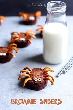 chocolate spider cookies with milk and sprinkles on the side, ready to be eaten