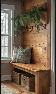 a wooden bench with some plants on it and two baskets under the bench next to it