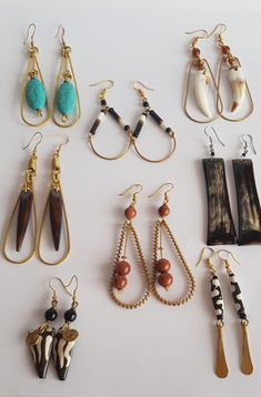 many different types of earrings on a white surface