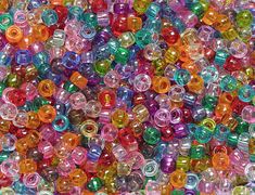 many different colored beads are stacked on top of each other in the same pattern and size