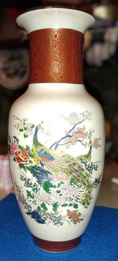 a white vase sitting on top of a blue table