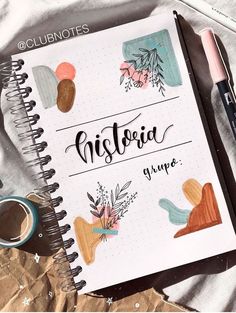 an open notebook with the words instagram written on it next to a cup of coffee