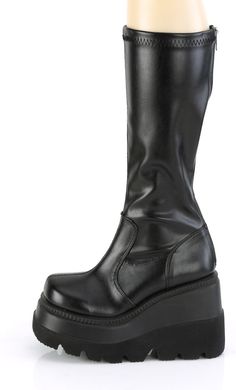 4 1/2" Wedge Platform Stretch Knee High Boot, Back Zipper - Fit Guide: True to Size - Heel Height: 4 1/2" Wedge Platform - Brand: Demonia - Shown in Women's Sizes - Country of Origin: Imported Synthetic Medium Width Platform Wedge Boots, Synthetic Closed Toe Platform Wedge Boots, Black Wedge Boots Medium Width, Black Wedge Heel Boots With Chunky Platform, Black Wedge Boots With Medium Width, Black Chunky Platform Wedge Boots, Black Knee-high Platform Wedge Boots, Black Synthetic Wedge Boots With Round Toe, Black Platform Knee-high Wedge Boots