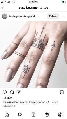 a woman's hand with tattoos on it and an arrow tattoo on the middle finger