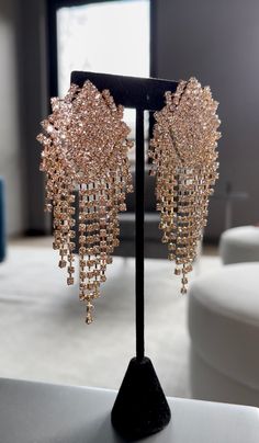 These earrings are glamorous and eye-catching, featuring a central geometric design encrusted with numerous small, sparkling stones. The main design tapers into multiple cascading strands of square-linked chains, each adorned with additional shimmering stones. The overall effect is luxurious and dynamic, perfect for adding a touch of elegance and sparkle to any formal outfit. Formal Outfit, Rhinestone Earrings, Geometric Design, Favorite Jewelry, Jewelry Earrings Dangle, Etsy Earrings, Dangle Drop Earrings, Dangle Earrings, Jewelry Earrings