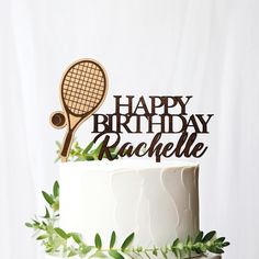 a happy birthday cake topper with a tennis racket on it's side