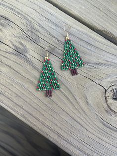 These Christmas tree earrings are made with top-quality Toho beads and are perfect to wear for the Holidays! Each pair of earrings will have the same pattern of red, gold, and green beads.  Details: * Handmade * Lightweight * Toho Seed Beads * Nylon Thread  * Nickel Free Ear Hook * Length - 1.88 in * Width - 1.10 in Handmade Holiday Beaded Earrings With Round Beads, Handmade Beaded Earrings For Holiday, Handmade Round Beaded Earrings For Holiday, Handmade Green Beaded Christmas Earrings, Handmade Green Beaded Earrings For Christmas, Handmade Green Beaded Earrings For Holiday, Holiday Green Handmade Beaded Earrings, Fringe Earring, Boho Earring