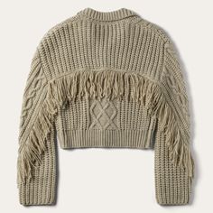 This cozy, wool-blend cable-knit cardigan sweater has a soft tan color, a front-button closure and stylish fringe accents at the back yoke and sleeves. Waist length, with longer, flowing sleeves, it offers easy elegance when worn with jeans, or a dash of bohemian flair when dressed up. Cable-Knit Fringe At Back Yoke And Sleeves Large Fold Down Collar Oversized Buttons 85% Acrylic, 15% Wool Imported Fringed Cardigan, Knit Fringe, Flowing Sleeves, Cowgirl Gifts, Cable Knit Sweater Cardigan, Fringe Cardigan, Free Spirit Style, Wide Trousers, Fringe Sweater