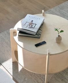 a coffee table with books and a plant on it