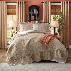 a bed in a bedroom with orange walls and beige drapes on the windowsill