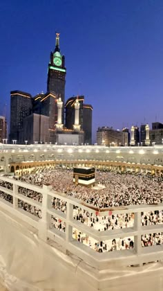 an aerial view of the grand mosque in the middle of the city at night time