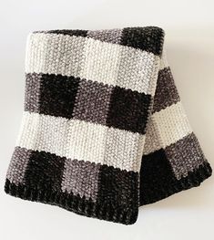 two black and white knitted blankets on top of each other