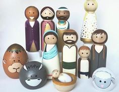 a group of wooden figurines sitting next to each other on a white surface