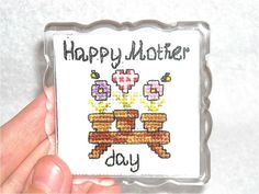 a hand holding up a card with the words happy mother's day on it