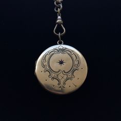 This regal turn of the century gold-filled European locket features a central engraved starburst design with a red paste stone surrounded by an artistic engraving. Although you might notice a few dings in this locket, they don't detract from its overall beauty. Bonus: this lovely locket has been paired with a Victorian-era gold-filled belcher chain that terminates in a fob clasp that could be used with ANY other pendant or locket. Snaps securely. Antique Medallion Jewelry With Historical Design, Collectible Historical Jewelry With Antique Finish, Historical Engraved Jewelry Gift, Formal Heirloom Medallion Locket Necklace, Collectible Antique Finish Historical Jewelry, Victorian Silver Locket Necklace In Brass, Victorian Style Silver Locket Necklace With Brass, Antique Silver Victorian Locket Necklace, Vintage Round Locket Necklace With Engraving Option