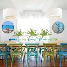 a dining room table with blue chairs and white walls