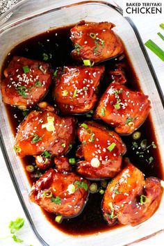 baked teriyaki chicken in a casserole dish with garnishes