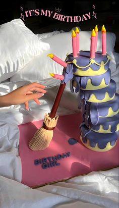 there is a birthday cake with candles and a broom on the floor next to it