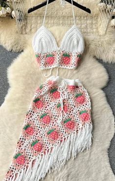 two piece swimsuit with strawberries on the bottom and fringe trimming around it