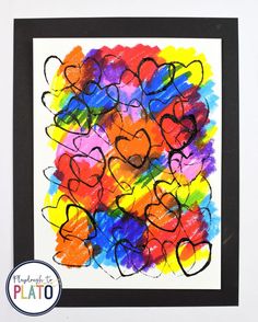 an art project with hearts painted on paper and framed in black frame for kids to make