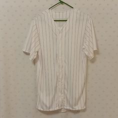 Size Adult Medium. White With Red Pinstripes. Button Down Front. Moisture Management. 100%Polyester. Front Shoulder Seam To Hemline 30" Pit To Pit 22" Sleeve Length 5.5" Back Shoulder Seam To Hemline 32". Washed In Cold Water Hung Dried. Never Worn. Excellent Condition. White V-neck Top With Contrast Stripes, Casual Striped Tops For Baseball Season, Casual White Baseball Jersey With Contrast Stripes, Casual Cotton Baseball Jersey With Three Stripes, White Cotton Baseball Jersey For Summer, Casual White Baseball Jersey For Summer, White V-neck Tops With Contrast Stripes, Back Shoulder, Cold Water