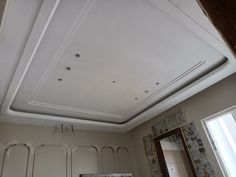 the ceiling in this bathroom is painted white and has many holes on it's sides