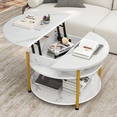 a living room with a couch, table and books on the coffee table in it