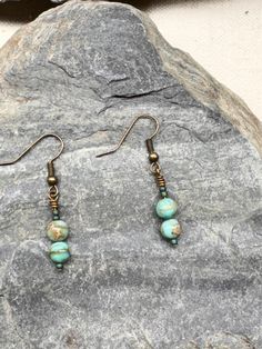 Get ready to elevate your boho style with these Turquoise Impression Jasper Brass Earrings! Made with stunning turquoise impression jasper beads and brass accents, these earrings are the perfect addition to any casual outfit. The lightweight design makes them comfortable to wear all day long, while the bohemian style adds a touch of creativity and individuality to your look. Whether you're going for a laid-back, beach vibe or a more edgy look, these earrings are versatile enough to match any sty Bohemian Turquoise Beaded Earrings With Brass, Bohemian Turquoise Beaded Earrings In Brass, Bohemian Turquoise Beaded Brass Earrings, Bohemian Turquoise Beaded Earrings, Adjustable Bohemian Patina Earrings, Bohemian Jasper Jewelry Nickel Free, Nickel Free Jasper Bohemian Jewelry, Nickel-free Bohemian Jasper Jewelry, Bohemian Amazonite Earrings For Gifts