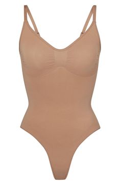 Updated for an even better fit, this fan-fave bodysuit from Kim Kardashian's SKIMS offers extra compression at the core and waist to cinch your natural shape. Strategically placed lines flatter your bust and provide definition, and the low back makes it easy to wear under a variety of outfits. Snap closure Scoop neck Adjustable straps Cotton-lined gusset 82% nylon, 18% spandex Machine wash, tumble dry Imported Skims Sculpting Bodysuit, Care Hair, Of Outfits, The Low, Natural Shapes, Low Back, Kim Kardashian, Snap Closure