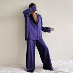 Silk Pajamas that you won't change out of and luckily, don't have to. Wear this soft and silky matching set all day long, or wear it out. Our Olivia Silk Pajamas is another sleepwear favorite this season and features a matching long sleeve top and wide-leg pant bottoms. The pants feature an elasticated waist, silky touch, and high waist. The long-sleeved top features a v-neckline, a loose fit, a single-breasted button closure, and a turn-down collar. The best matching set for lounging around the Wide Leg Pant Suit, Pajama Fashion, Silk Sleepwear, Silk Pajama Set, Long Sleeve Tops Casual, Satin Pajamas, Sleepwear Sets, Satin Shirt, Silk Pajamas