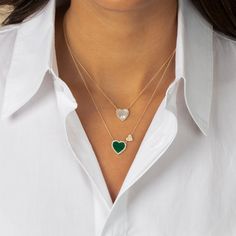 Add a touch of elegance with Adina Eden’s Pavé Diamond Colored Stone Heart Necklace. Crafted in 14K gold, this stunning necklace features a 12mm heart pendant adorned with mother of pearl, onyx, malachite, and turquoise gemstones, surrounded by 26 brilliant round-cut natural diamonds totaling .16 carats. The 14-inch chain includes two 1-inch extenders, allowing for adjustable length and versatile styling options. This necklace brings a perfect blend of colorful charm and refined sparkle, making Double Heart Necklace, Colored Stone, Double Heart, Stone Heart, Stunning Necklace, Gem Stone, Turquoise Gemstone, Pave Diamonds, Heart Necklace