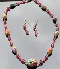 "When I first started collecting Millefiori, I came across the wedding cake bead. Made famous in Venice, wedding cake beads look like little cakes with \"icing\" of swirls, dots, flowers and aventurine, which consists of metallic bits, usually copper, to give it sparkle.  Millefiori glass beads were made famous in Venice in the 1800s millefiori\"means \"thousand flowers\". I also love the very intricate designs in the mosaic beads with all the faces in the beads, and the intricate designs . Both types of beads are made using thin rods of different colors of glass are bundled together, with the ends of the rods forming a design, such as flowers. The millefiori technique involves the production of glass canes or rods, known as murrine, with multicolored patterns which are viewable only from Oval Czech Glass Jewelry As Gift, Oval Czech Glass Jewelry For Gift, Handmade Czech Glass Jewelry With Oval Beads, Round Beaded Murano Glass Jewelry, Beaded Murano Glass Jewelry, Traditional Murano Glass Jewelry Gift, Round Murano Glass Beaded Jewelry, Oval Beaded Jewelry As A Gift, Czech Glass Oval Beads Jewelry For Jewelry Making