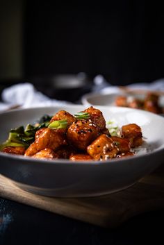 a white bowl filled with food on top of a wooden table