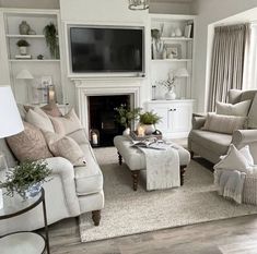 a living room filled with furniture and a flat screen tv mounted on the wall over a fireplace