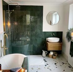 a bath room with a tub a sink and a mirror on the wall in it