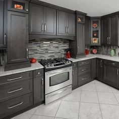 a kitchen with gray cabinets and stainless steel appliances